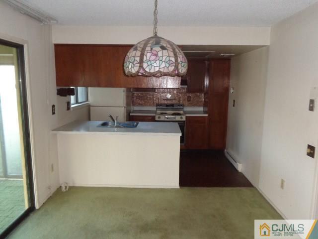 31 A Haddon Road Monroe Township, NJ 08831 - Photo 5 of 13 a kitchen with a stove and a refrigerator