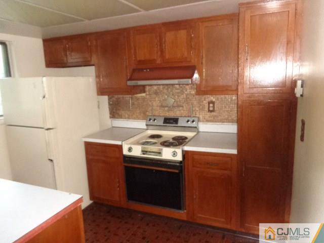 31 A Haddon Road Monroe Township, NJ 08831 - Photo 6 of 13 a kitchen with a stove and a refrigerator