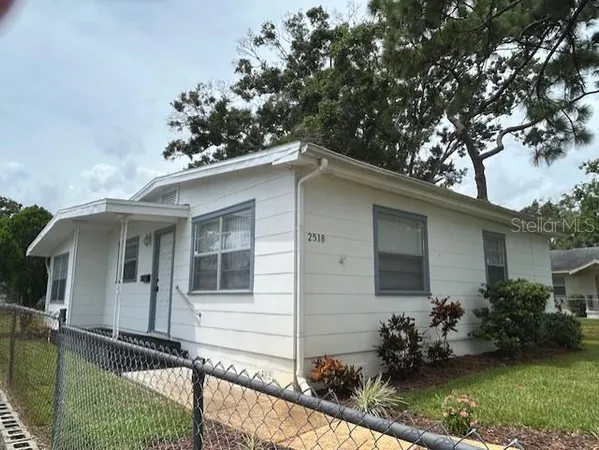 a front view of house with yard and outdoor seating