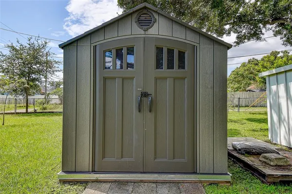 a view of a house with a yard and sitting area