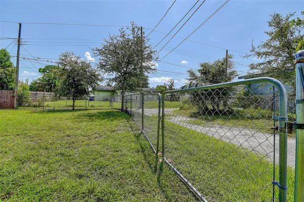 a view of a backyard with a garden and trees