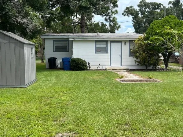 a view of a backyard with large trees