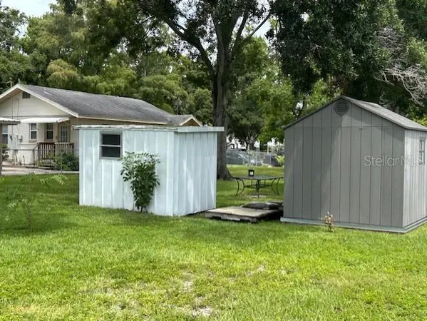 a view of a house with backyard and a garden
