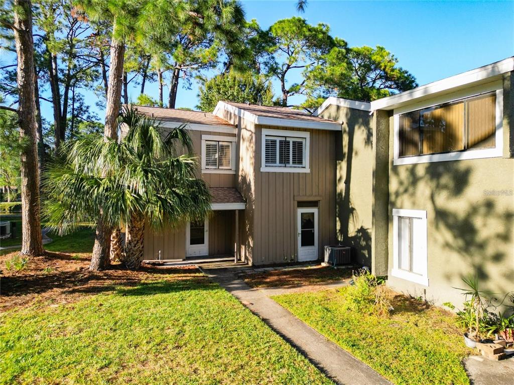 6021 Windhover Drive, Unit F11 Orlando, FL 32819 - Photo 1 of 1 a front view of a house with yard