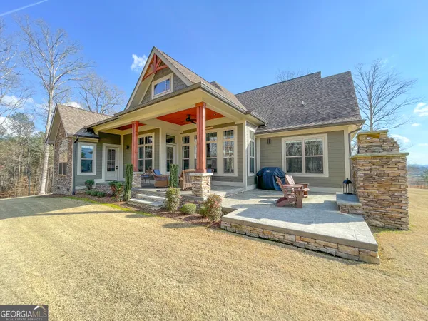 a front view of a house with a yard and outdoor seating