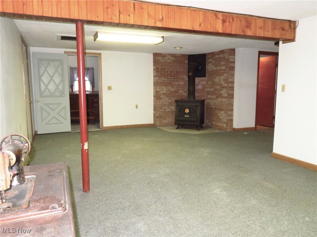 38505 Sugar Ridge Road North Ridgeville, OH 44039 - Photo 32 of 44 This is a view of the multi-functional space in the lower level walk out bsmt. The Enclosed sun porch (W/Hot tub) is just through the door to the left of the wood burner stove