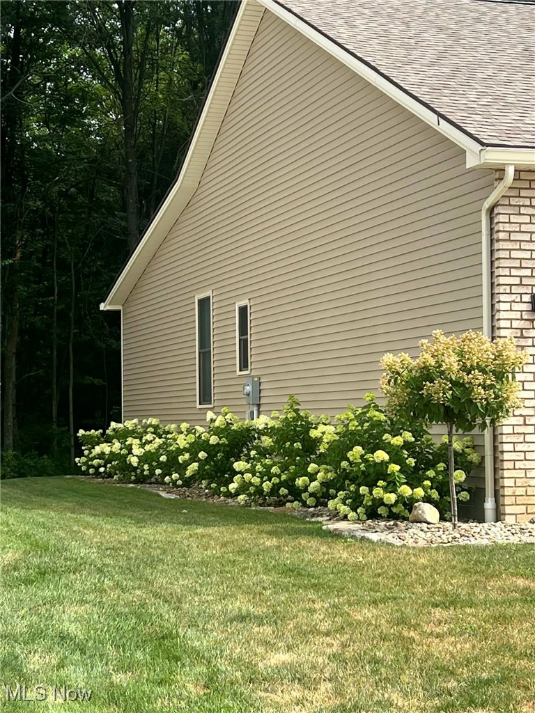 6580 Abbey Road North Canfield, OH 44406 - Photo 4 of 32 View of side of property featuring roof with shingles, brick siding, and a yard