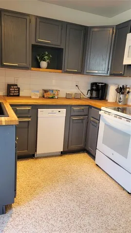 a kitchen with granite countertop a sink and cabinets