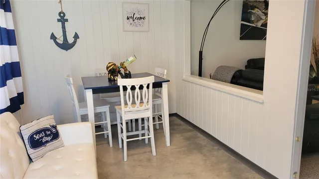 a view of a dining room with furniture and a rug