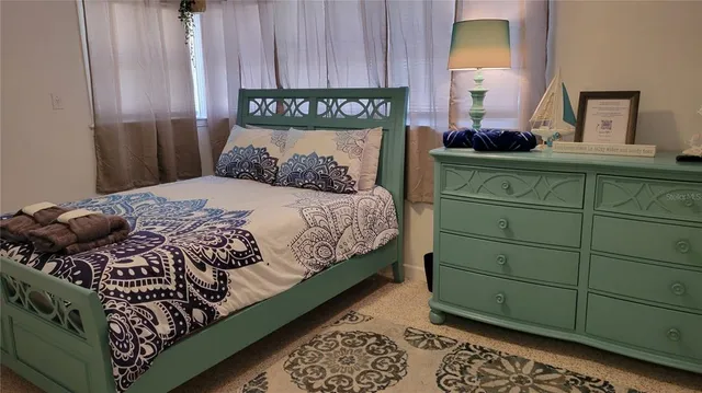 a bedroom with a bed and a dresser