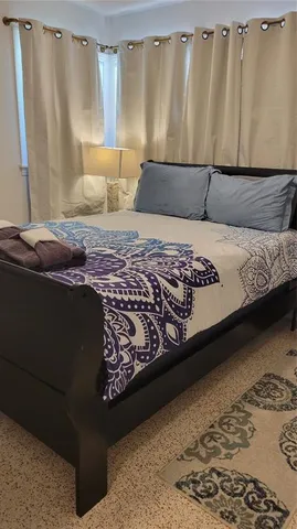 a bedroom with a bed and a couch