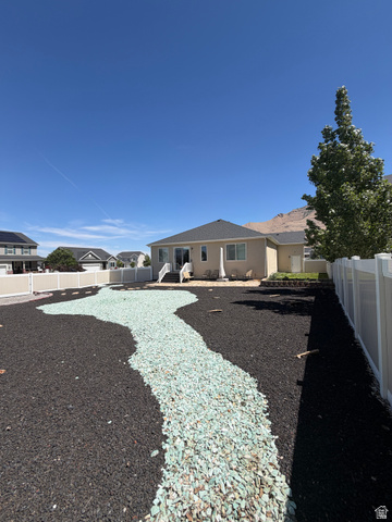 118 Tram Rock Rd. Lake Point, UT 84074 - Photo 34 of 34 Landscaped backyard featuring black lava rock and a winding light green decorative rock pathway