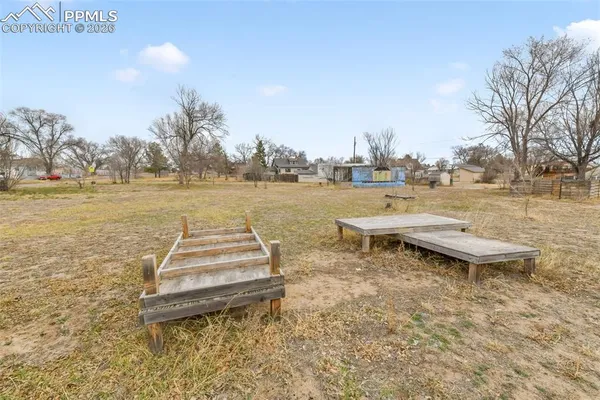 a view of a lake with a yard and wooden floor