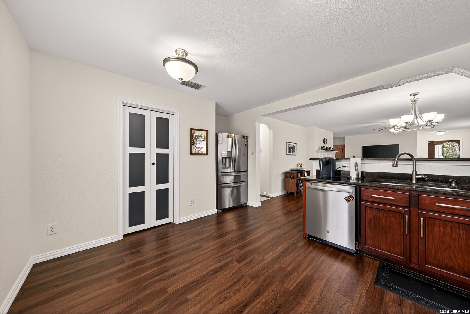 7942 Ruidoso Chase Selma, TX 78154 - Photo 14 of 26 a kitchen with stainless steel appliances granite countertop a sink cabinets and wooden floor