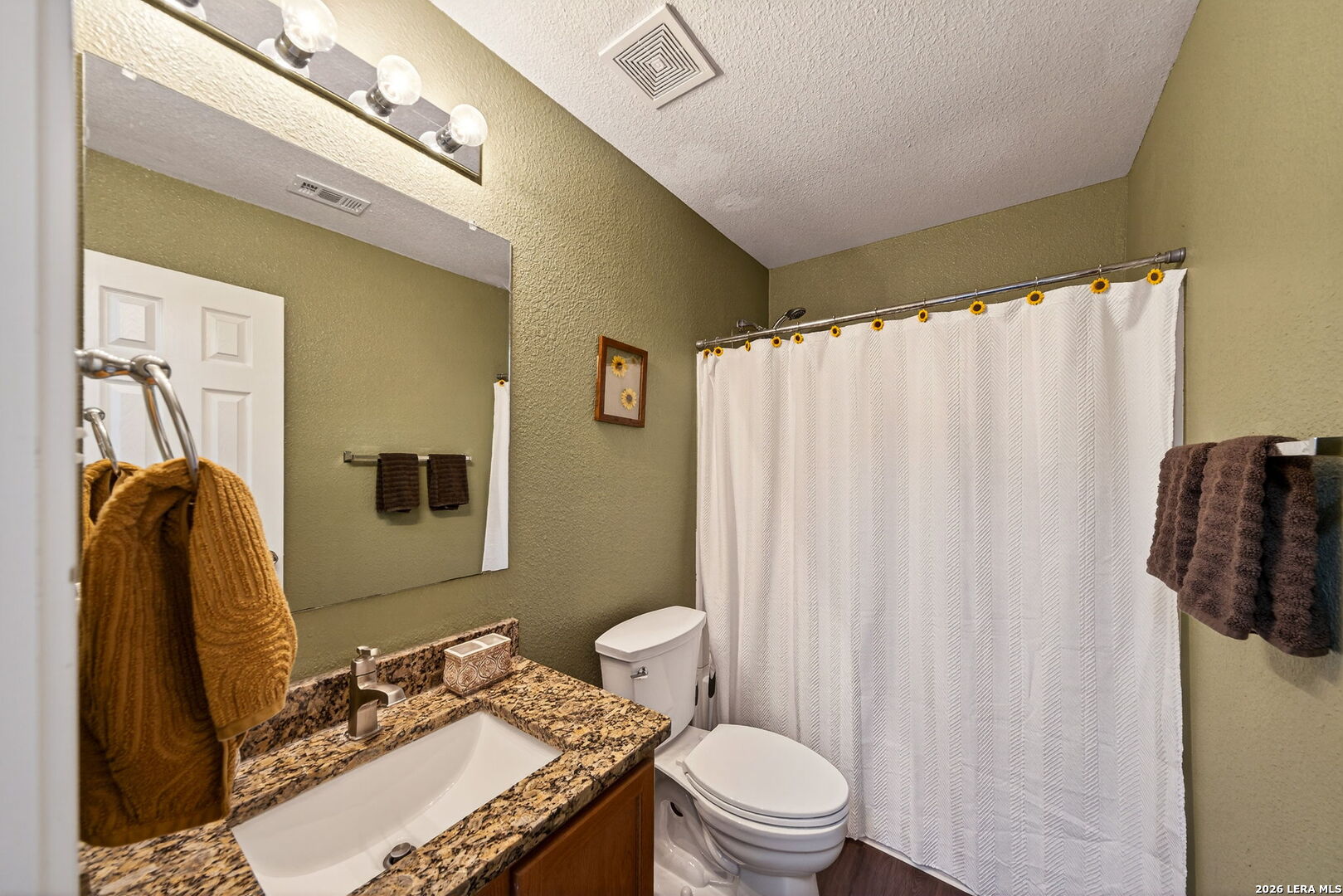 7942 Ruidoso Chase Selma, TX 78154 - Photo 17 of 26 a bathroom with a granite countertop sink toilet and shower