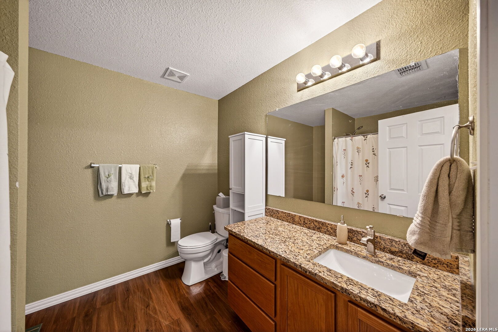 7942 Ruidoso Chase Selma, TX 78154 - Photo 19 of 26 a bathroom with a granite countertop double vanity sink and a mirror