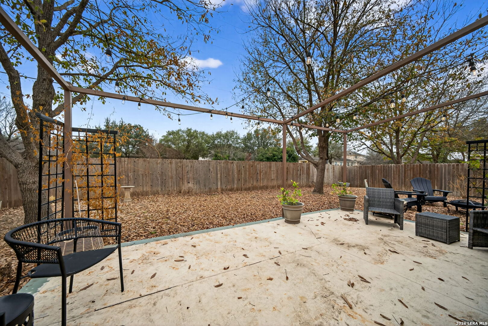 7942 Ruidoso Chase Selma, TX 78154 - Photo 22 of 26 a view of backyard with wooden fence and large trees