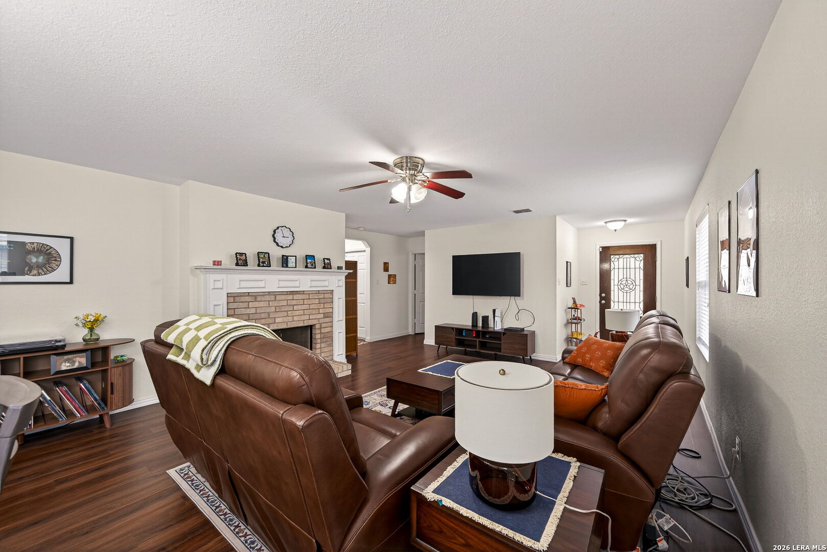 7942 Ruidoso Chase Selma, TX 78154 - Photo 5 of 26 a living room with furniture a fireplace and a flat screen tv