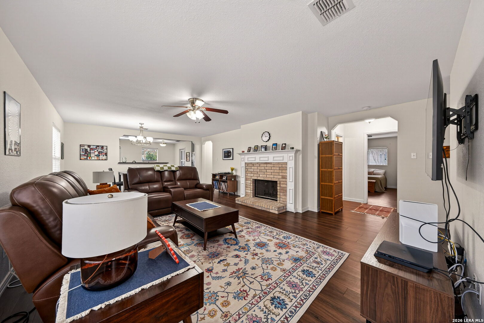 7942 Ruidoso Chase Selma, TX 78154 - Photo 7 of 26 a living room with furniture a fireplace and a table