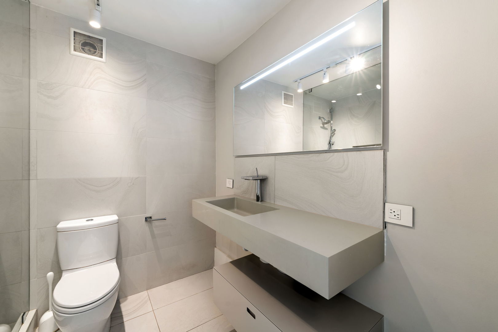 1516 North State Parkway, Unit 5D Chicago, IL 60610 - Photo 13 of 34 a white toilet sitting next to a bathroom sink