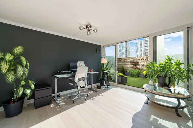 a living room with furniture potted plant and a window