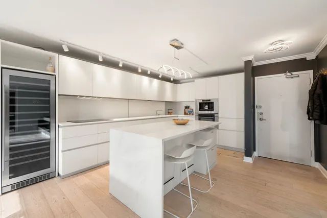 a kitchen with kitchen island a sink appliances and cabinets