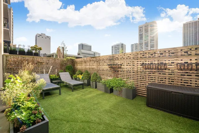 a terrace with outdoor seating and city view