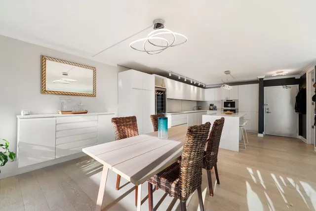 a kitchen with a table chairs refrigerator and microwave