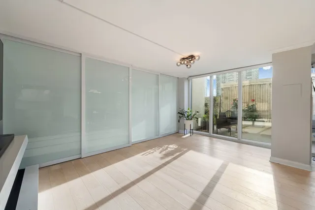 a view of a room with wooden floor and sliding door