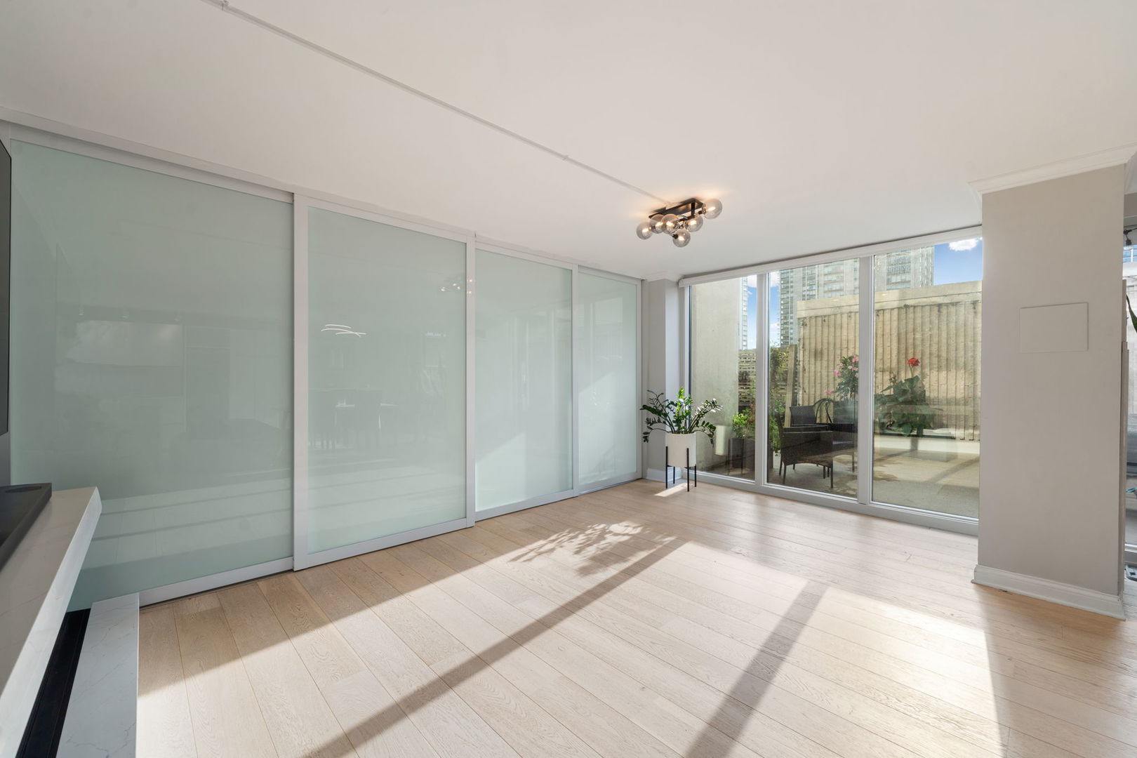 1516 North State Parkway, Unit 5D Chicago, IL 60610 - Photo 10 of 34 a view of a room with wooden floor and sliding door