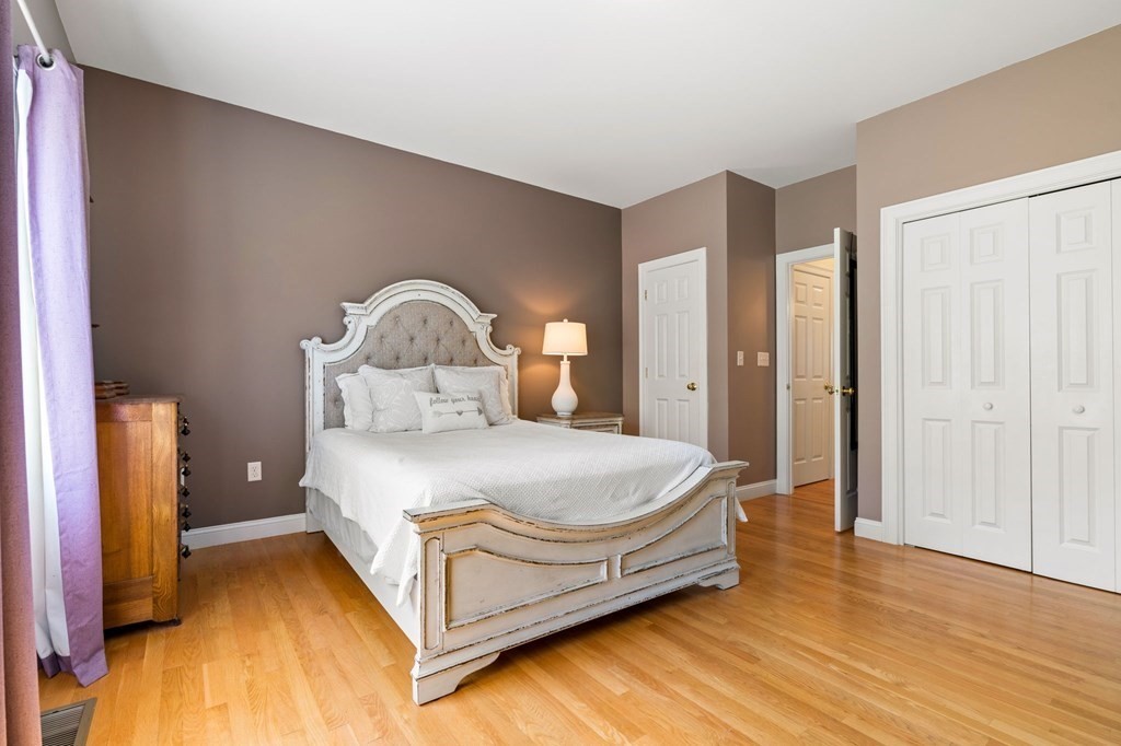 2 Hannah Dodge Road, Unit A Littleton, MA 01460 - Photo 14 of 28 a bedroom with a bed and a mirror