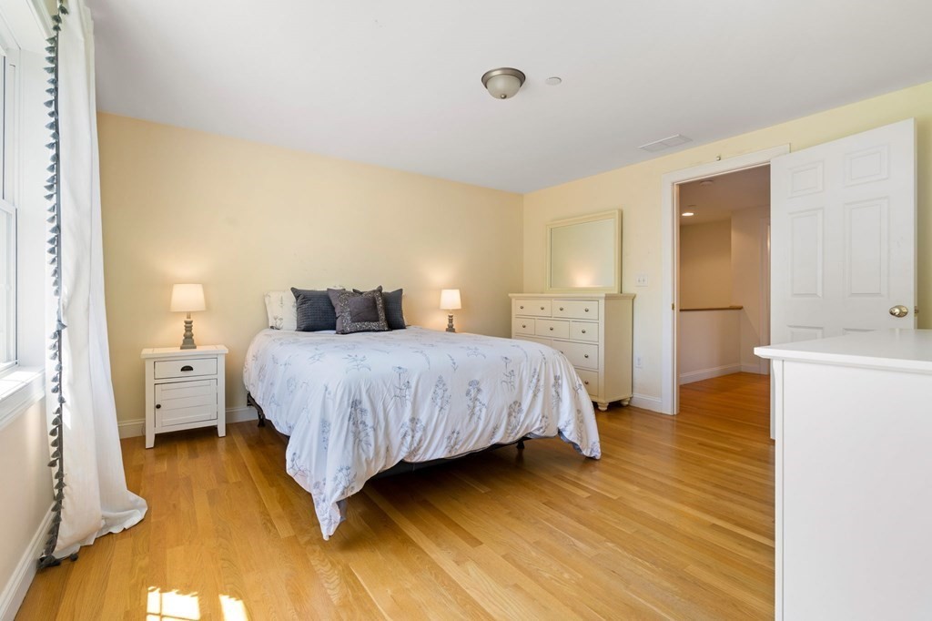 2 Hannah Dodge Road, Unit A Littleton, MA 01460 - Photo 19 of 28 a bedroom with a bed and wooden floor