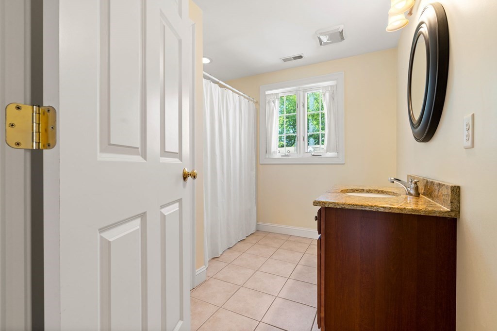 2 Hannah Dodge Road, Unit A Littleton, MA 01460 - Photo 21 of 28 a bathroom with a sink and a mirror