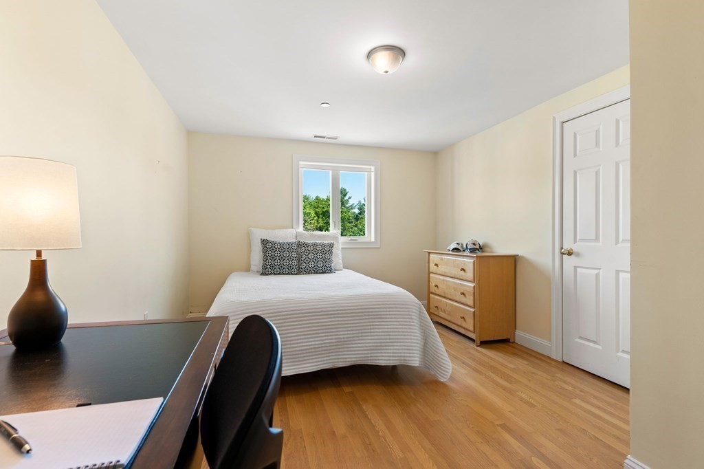 2 Hannah Dodge Road, Unit A Littleton, MA 01460 - Photo 22 of 28 a bedroom with a bed and wooden floor