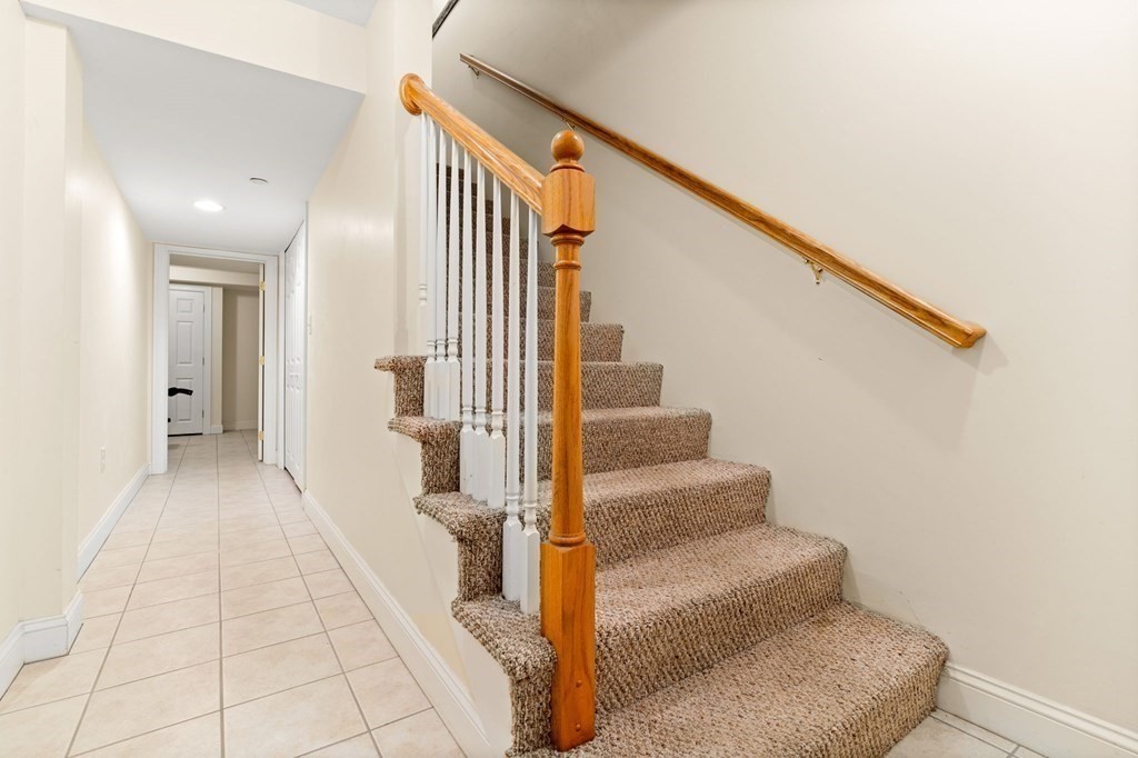 2 Hannah Dodge Road, Unit A Littleton, MA 01460 - Photo 23 of 28 a view of a hallway with wooden floor and staircase