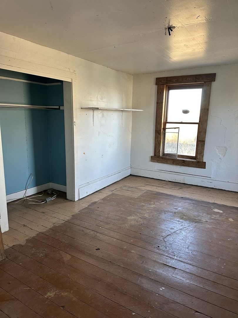 18683 Malvern Road Morrison, IL 61270 - Photo 17 of 18 an empty room with wooden floor and windows