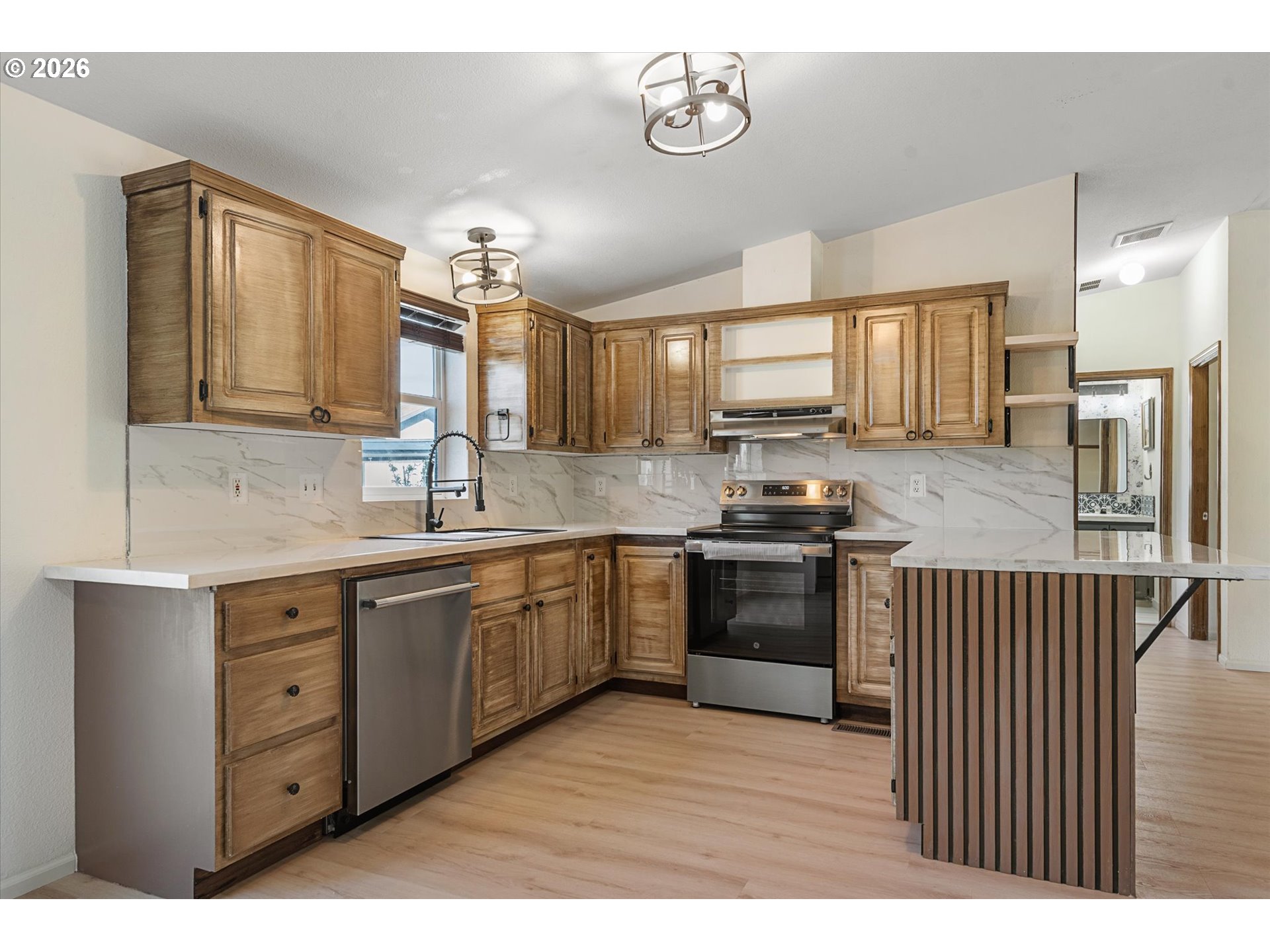 14386 Ben-Dier Road Baker City, OR 97814 - Photo 11 of 42 a kitchen with a sink window and cabinets