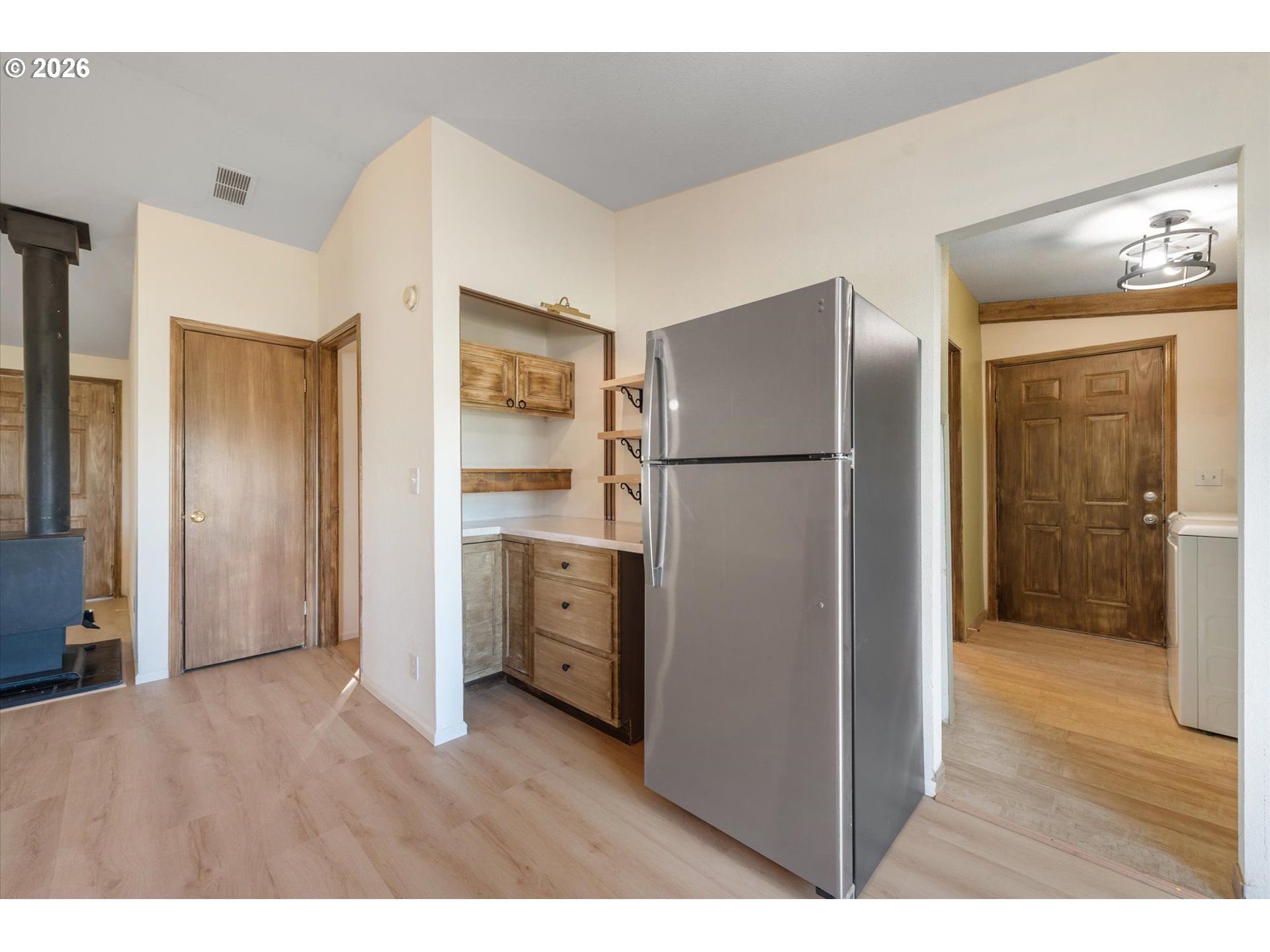 14386 Ben-Dier Road Baker City, OR 97814 - Photo 15 of 42 a kitchen with stainless steel appliances a refrigerator and a wooden floor