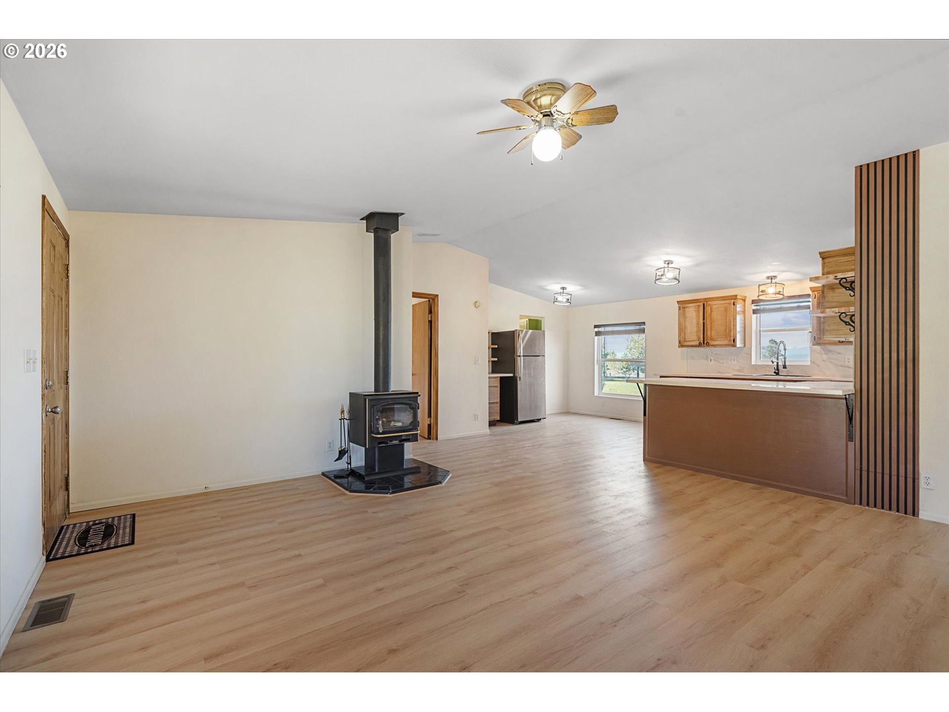 14386 Ben-Dier Road Baker City, OR 97814 - Photo 19 of 42 a view of a kitchen with wooden floor and a ceiling fan
