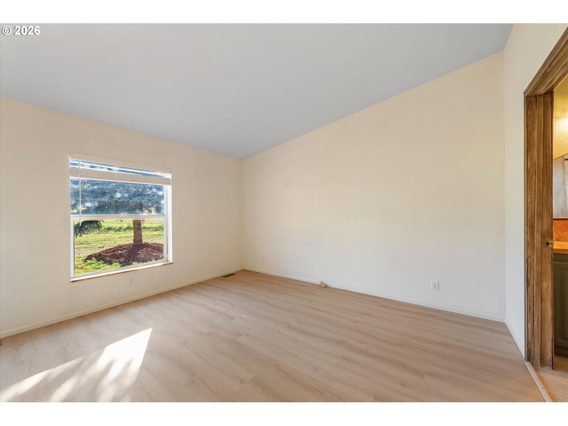 14386 Ben-Dier Road Baker City, OR 97814 - Photo 20 of 42 an empty room with wooden floor and windows