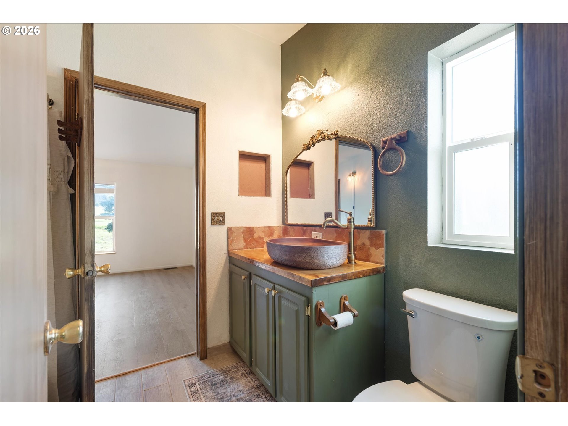 14386 Ben-Dier Road Baker City, OR 97814 - Photo 22 of 42 a bathroom with a toilet a sink and mirror