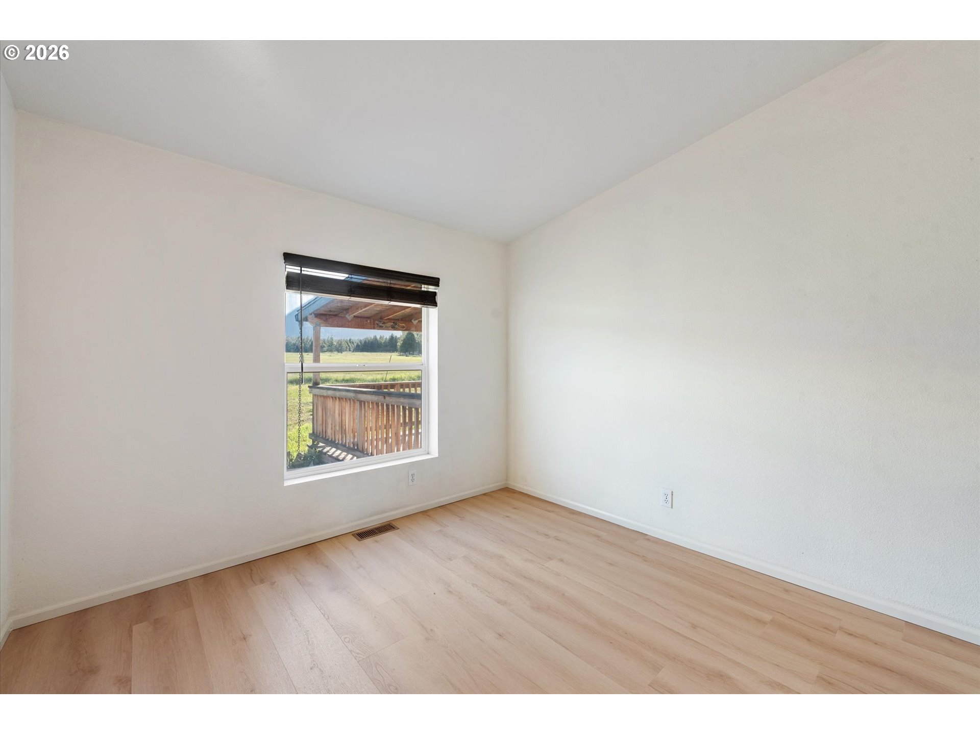 14386 Ben-Dier Road Baker City, OR 97814 - Photo 27 of 42 a view of an empty room with wooden floor and a window