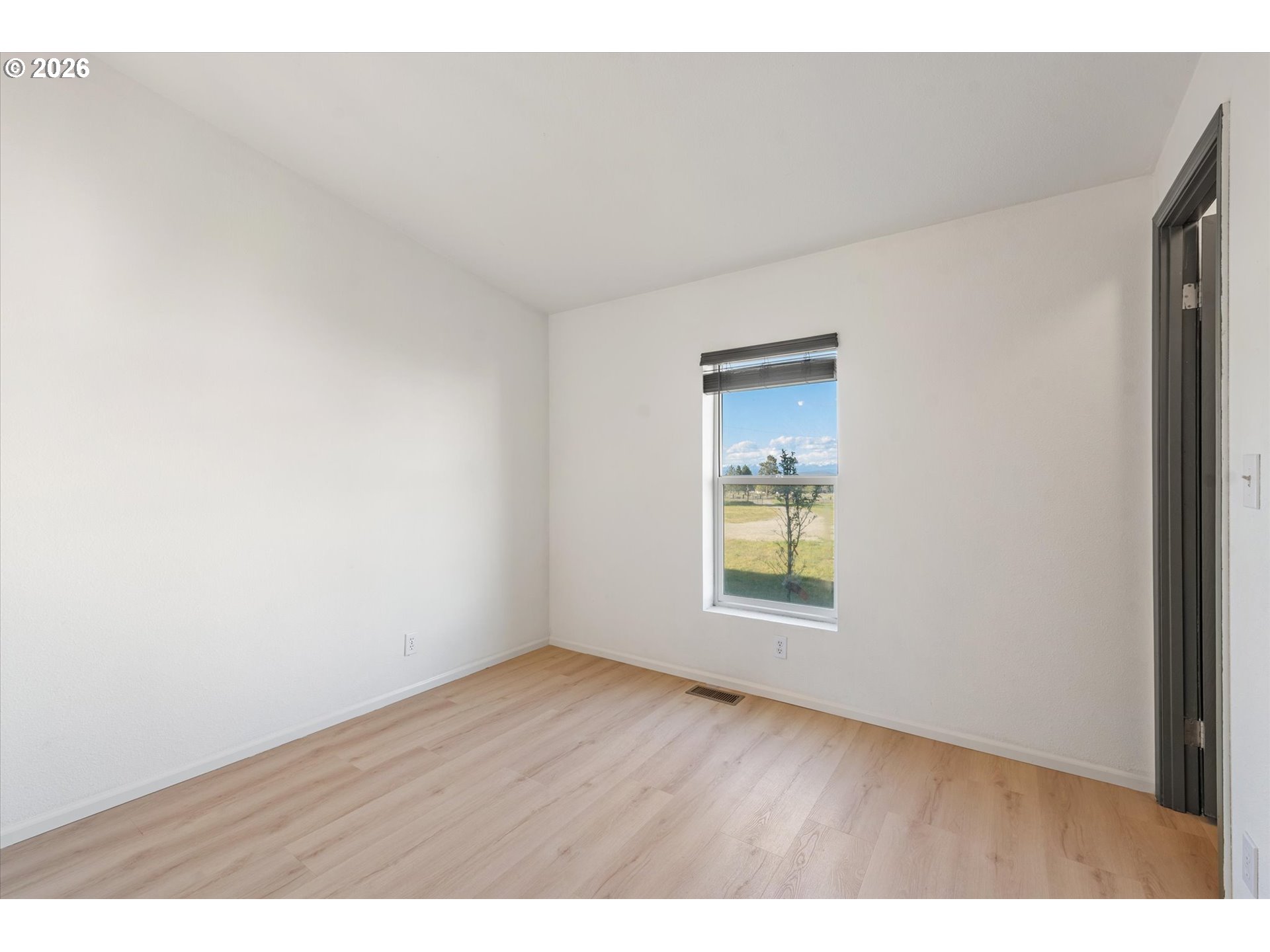 14386 Ben-Dier Road Baker City, OR 97814 - Photo 28 of 42 a view of an empty room with wooden floor and a window