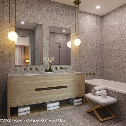 a living room with a couch and two mirrors