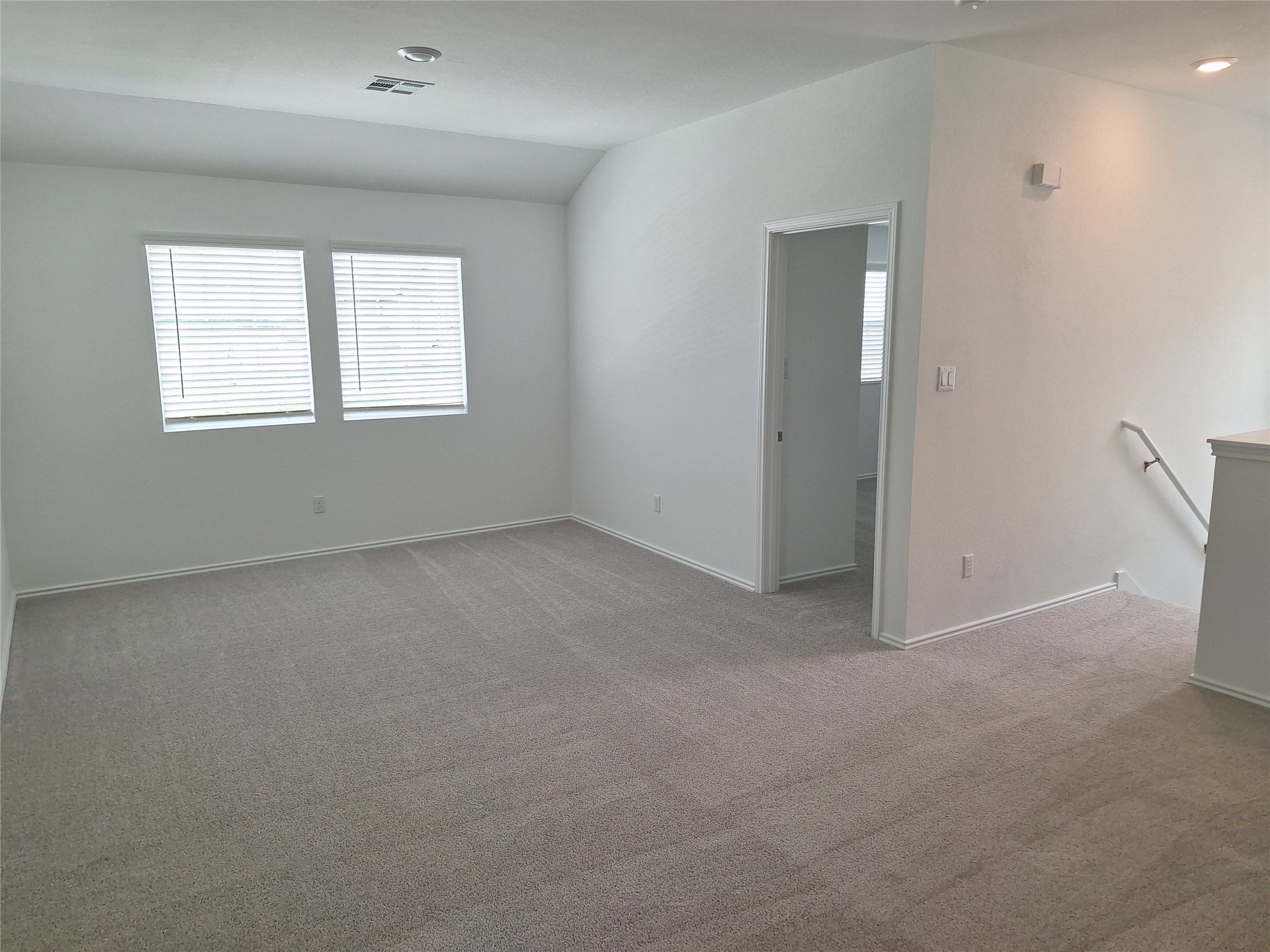 18001 Prairie Falcon Way Pflugerville, TX 78660 - Photo 12 of 38 Neutral tone carpeting, white walls, and white trim throughout this versatile living space