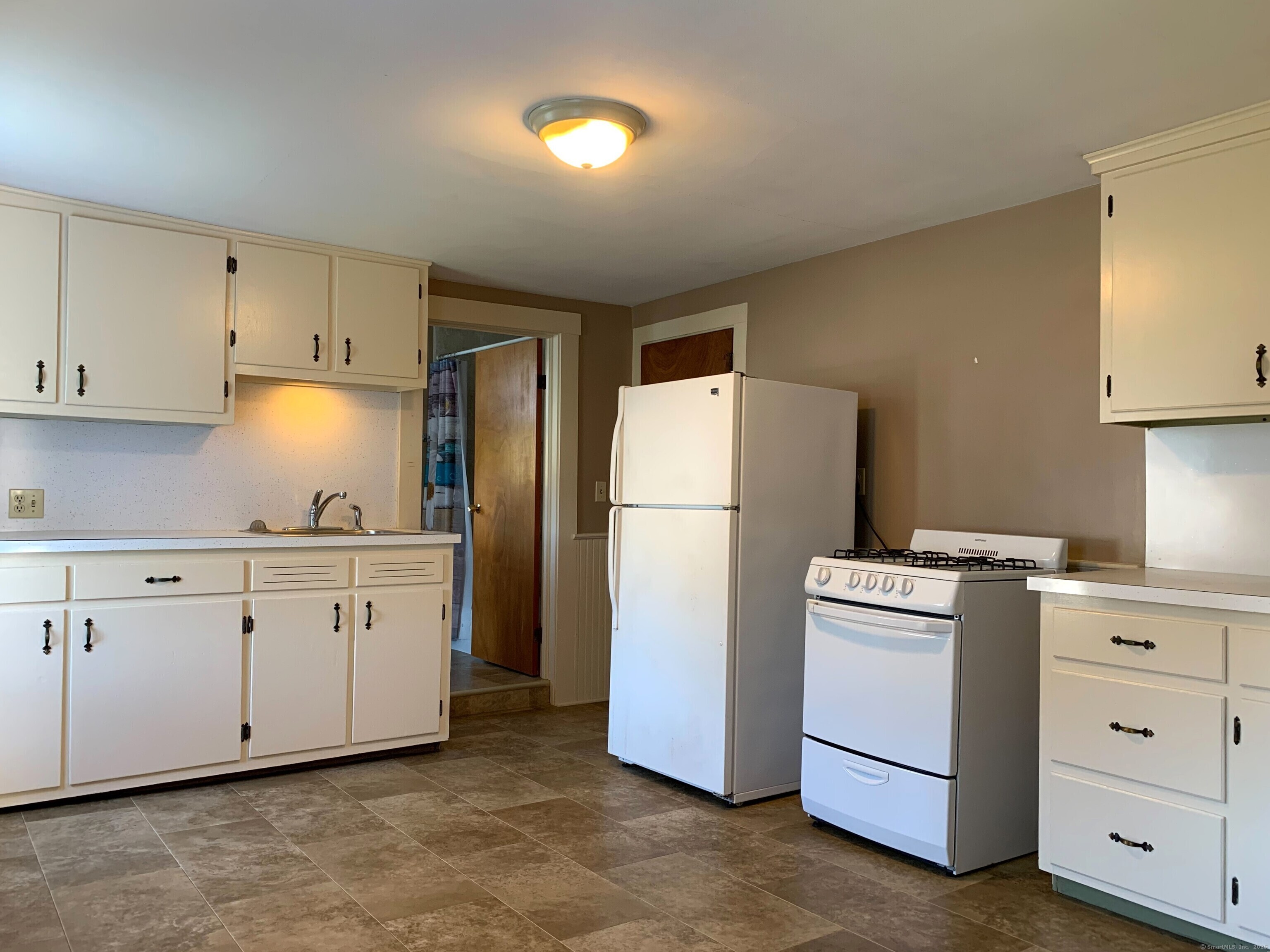 96 Main Street, Unit 2 Branford, CT 06405 - Photo 8 of 10 a kitchen with cabinets a refrigerator and a stove