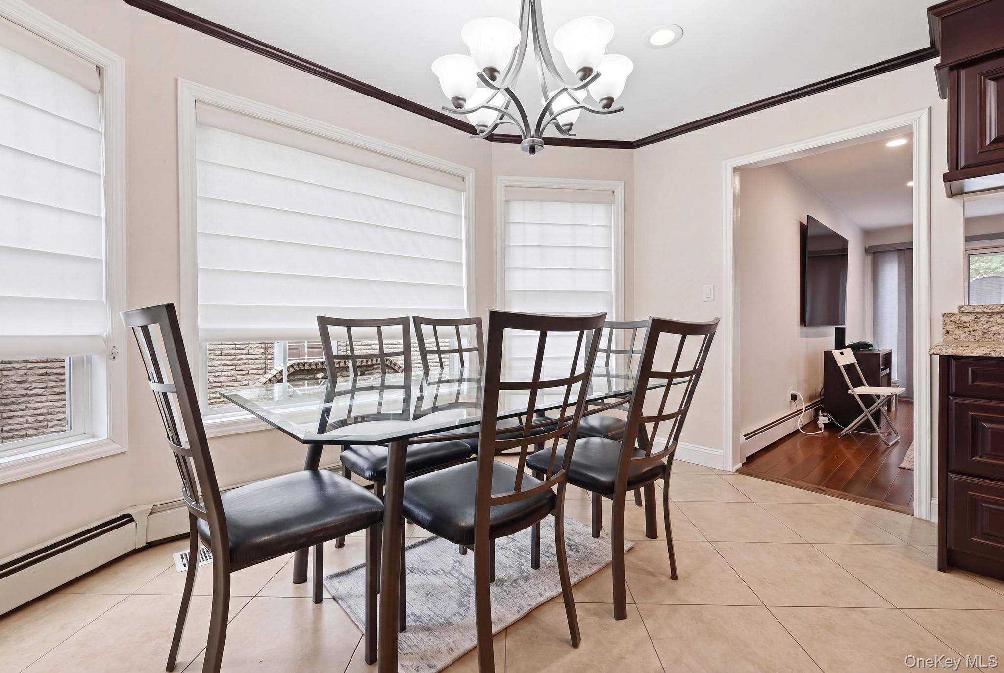 19 Sunset Road West Albertson, NY 11507 - Photo 3 of 24 Breakfast nook featuring three windows with white window treatments, a chandelier and recessed lighting