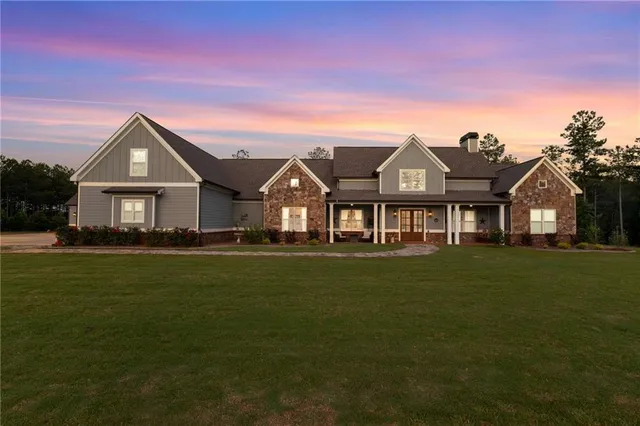 a view of a house with swimming pool and a yard