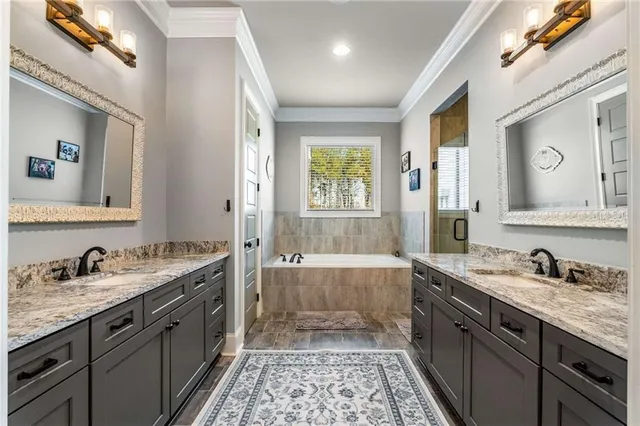 a spacious bathroom with a granite countertop sink a mirror and a shower
