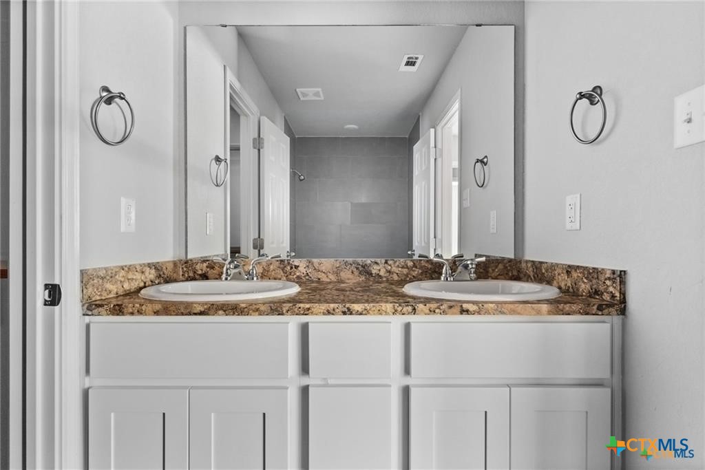 117 East Valley Road Harker Heights, TX 76548 - Photo 21 of 33 a bathroom with a granite countertop sink and a mirror